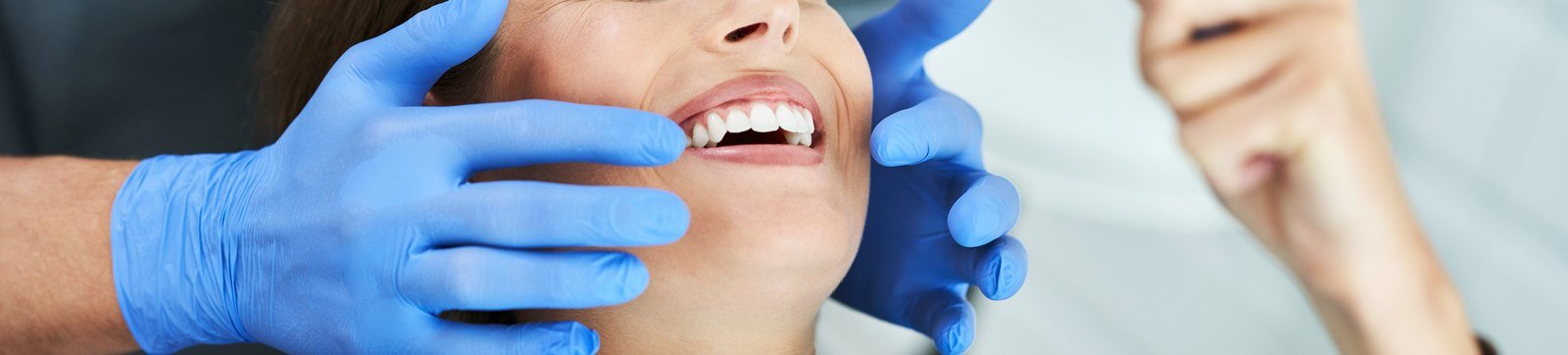 Dentist repairing a patient's front tooth with tooth-colored bonding resin in Orlando