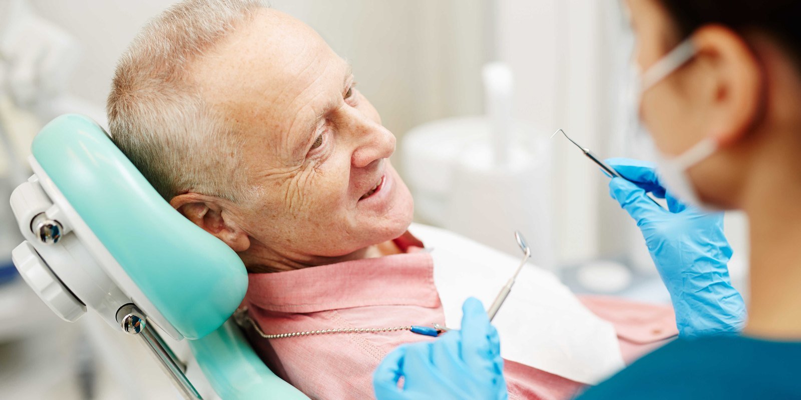 A full denture model at University Dental Group in Orlando Older adult patient discussing denture options with the dentist at University Dental Group in Orlando, FL