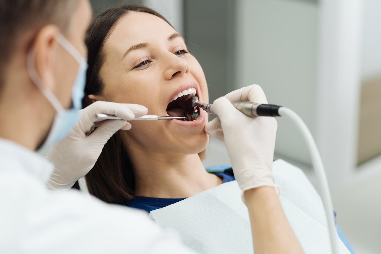 Prompt care can keep an infection from spreading Dentist treating a patient's tooth at University Dental Group