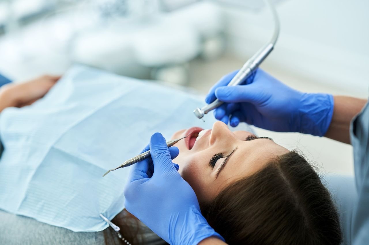 Dentist treating a patient's teeth during a dental visit